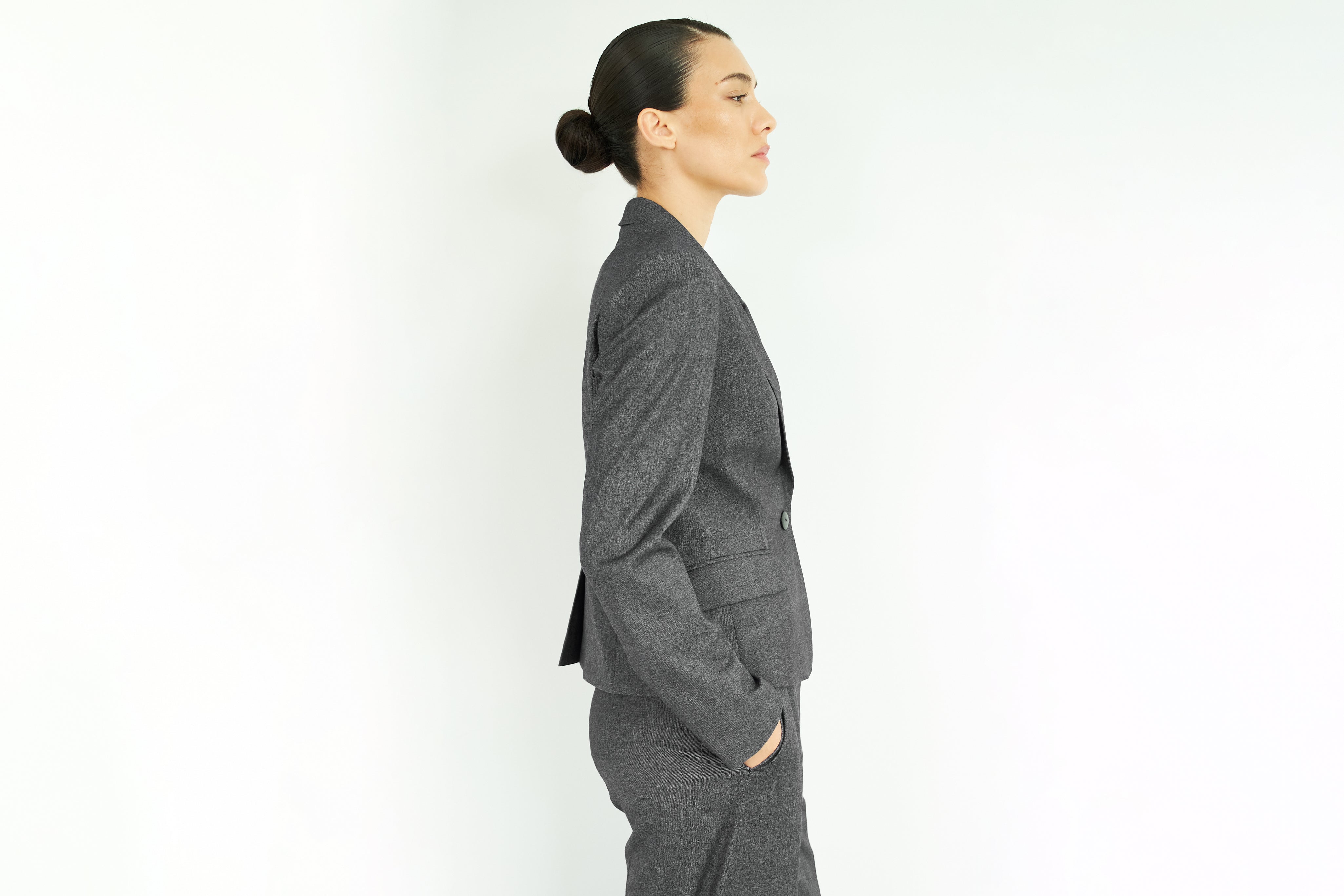 Woman with gray suit seen from the side 